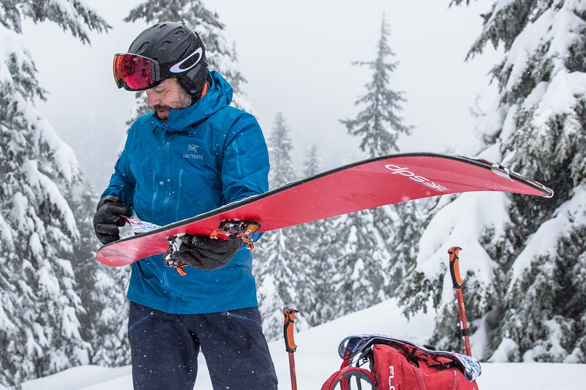 skier taking off skins from skis